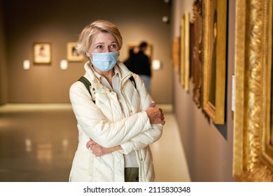 Woman Visitor Wearing An Antivirus Mask In Museum Looking At Pictures