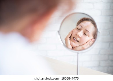 A Woman With Vitiligo Disease Looks In The Mirror