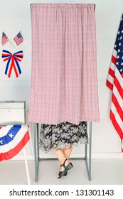 A Woman Voter Inside A Voting Booth At His Local Polling Place.