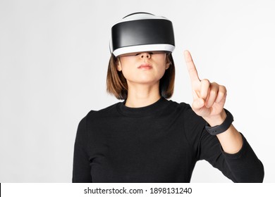 Woman with VR headset touching invisible screen futuristic technology
