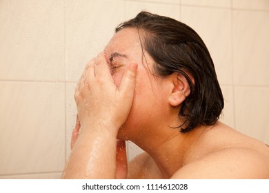 A Woman Waashes Her Face Under A Shower Stream 