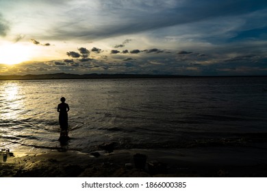 a woman wades in water - Powered by Shutterstock
