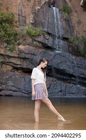 Woman Wading In Waterfall Pool