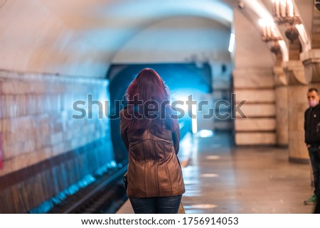 Woman wait at a subway station in Kiev.