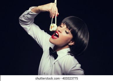 Woman In Waiter Style Eat Sushi At Night, Dinner In Restaurant