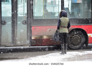 Woman waiting for bus in snow storm