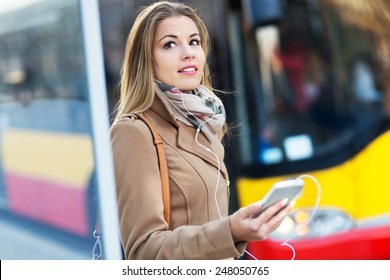 Woman Waiting at Bus Stop