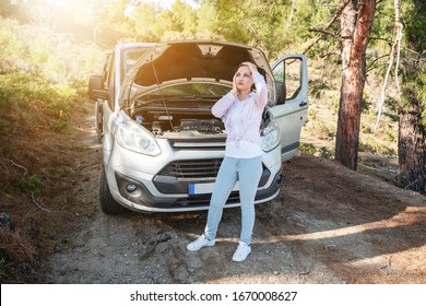 Woman is waiting desperately with open car hood for support of troubleshoot automobile. Transportation and vehicle concept.