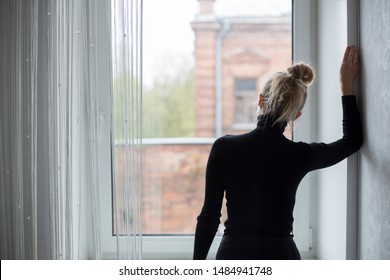 Woman waiting and looking out the window