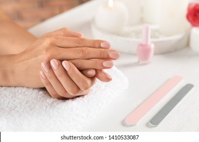 Woman waiting for manicure at table, closeup with space for text. Spa treatment