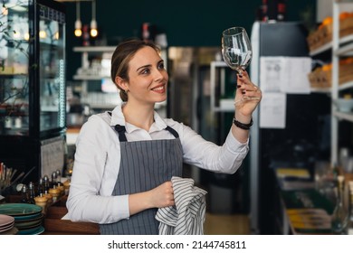 woman waitress polishing wine glass - Powered by Shutterstock