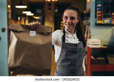 Woman Waitress Preparing Take Away Food In Restaurant
