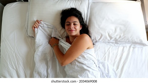 Woman Waking Up In The Morning, Husband Opening Blinds Shining Light Through Window And Lying In Bed With Wife