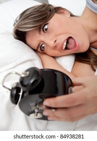 Woman Waking Up And Running Late Looking At The Alarm Clock