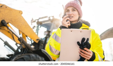 Woman With Walkie Talky On Compost Facility Dispatching Deliveries