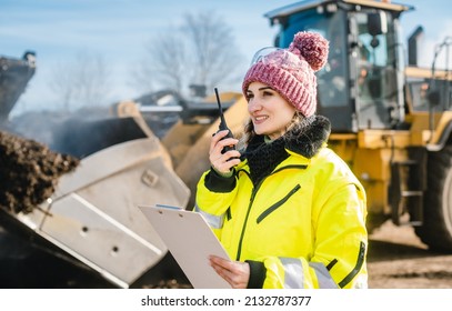 Woman With Walkie Talky On Compost Facility Dispatching Deliveries