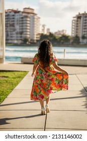 Woman Walking Away And Pulling On Dress