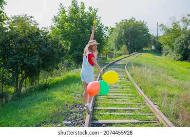 woman walking with balloons on the railroad.  - Powered by Shutterstock