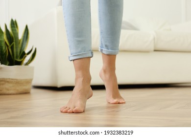 Woman Walking Barefoot At Home, Closeup. Floor Heating Concept