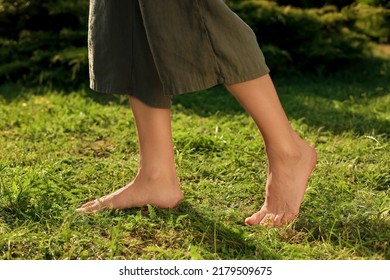 Woman Walking Barefoot On Green Grass Outdoors, Closeup