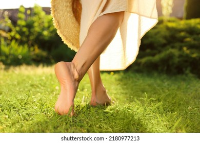 Woman walking barefoot on green grass outdoors, closeup - Shutterstock ID 2180977213