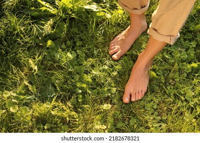 Woman walking barefoot on green grass outdoors, above view. Space for text - Shutterstock ID 2182678321