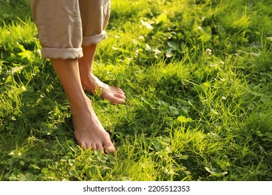 Woman walking barefoot on green grass outdoors, closeup. Space for text - Shutterstock ID 2205512353