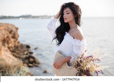 woman walking by sea. summer light sunny portrait. smiling girl with long hair and beautiful smile. summer girl portrait