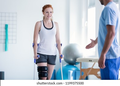 Woman Walking With Crutches During Physiotherapy