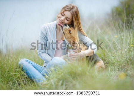 Similar – Happy smiling dog with its pretty young owner