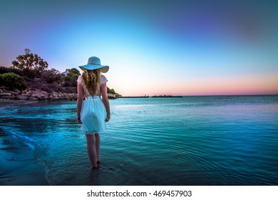 Woman Walking Down The Beach At Sunset. Beautiful Sunset Sea View In Cyprus Island