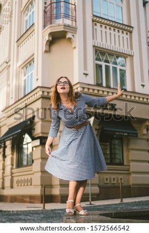 woman walking in dress in old city. Fashion Style Photo Of A Young Girl. happy stylish woman at old european city street. Tourist background of hotel. Man near building facade old european hotel.