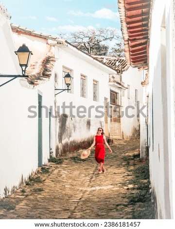 woman walking in front of historic houses in the city of Goias, state of Goias