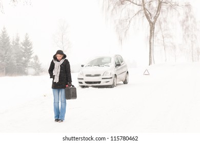 Woman walking with gas can snow car road winter trouble