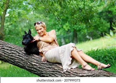 woman walking with her dog in a park  - Powered by Shutterstock