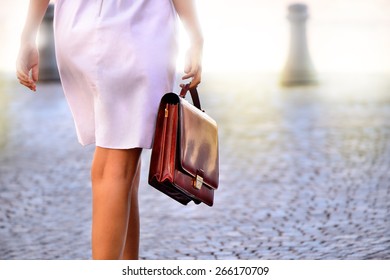 Woman Walking Home After Work With Portfolio Bag