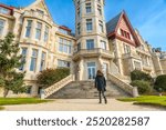 A woman walking in the Magdalena Palace in the city of Santander, Spain