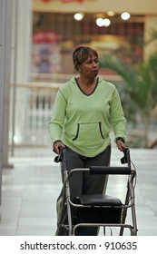 Woman Walking In Mall Using Walker