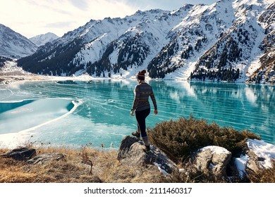 A woman walking near a frozen mountain lake, Almaty, Kazakhstan - Powered by Shutterstock