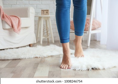 Woman Walking On Fluffy Carpet At Home