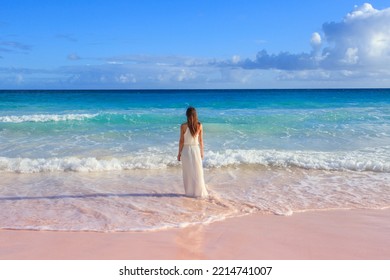 Woman Walking On Horseshoe Bay Beach In Bermuda, Famous For Its Pink Sand 