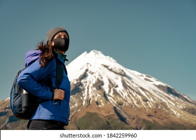 Woman walking on mountain wearing face mask. Covid-19 concept. - Powered by Shutterstock