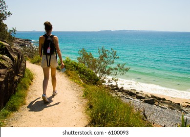 Woman walking on oceanside trail