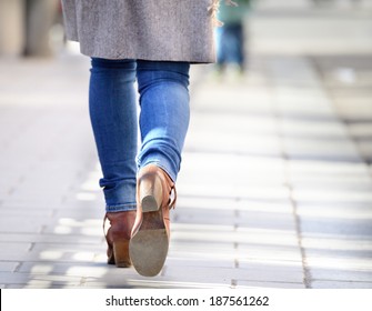 Woman Walking On Sidewalk