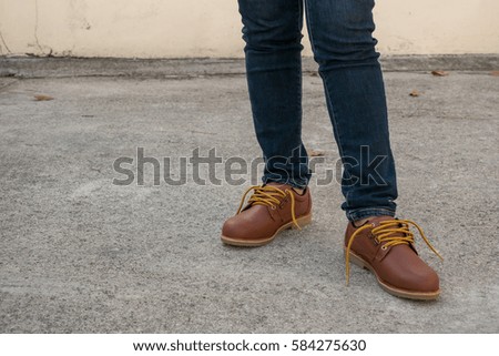 Woman walking on sidewalk, safety shoe close-up.