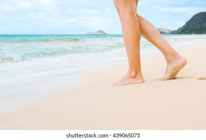 Woman walking on a white sand beach in beautiful Hawaii.  - Powered by Shutterstock