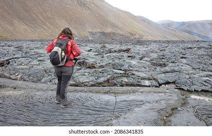 Woman Walking Over The New Lavafield Of The Volcano Eruption At Fagradalsfjall, Iceland