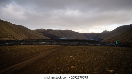 Woman Walking Over The New Lavafield Of The Volcano Eruption At Fagradalsfjall, Iceland