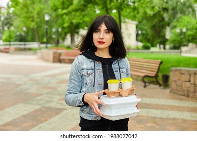 Woman Walking In The Park, Holding A Take Away Food And Coffee, Having Lunch Break From Work.