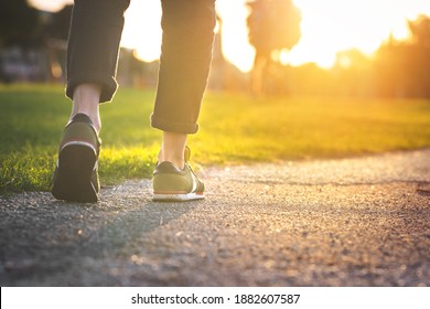 Woman walking in the park, outdoors. Closeup on shoe with rolled up jeans. Taking a step. New life concept - Powered by Shutterstock